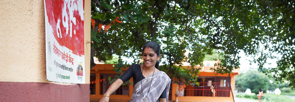 Woman smiling as she measures grain moisture