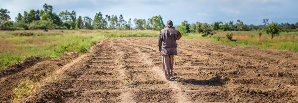 Man walking by himself in a field in Kenya