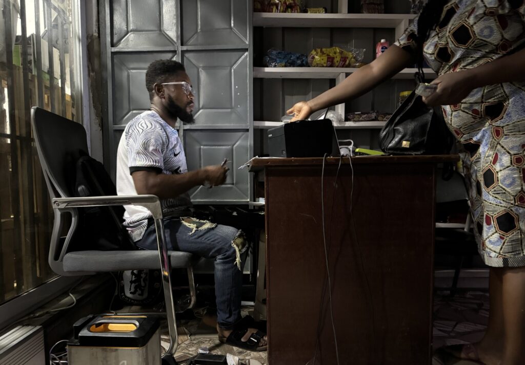 Man using a battery to power cash register